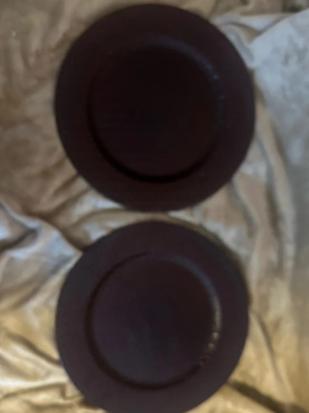 Set of 2 metallic brown plate chargers.